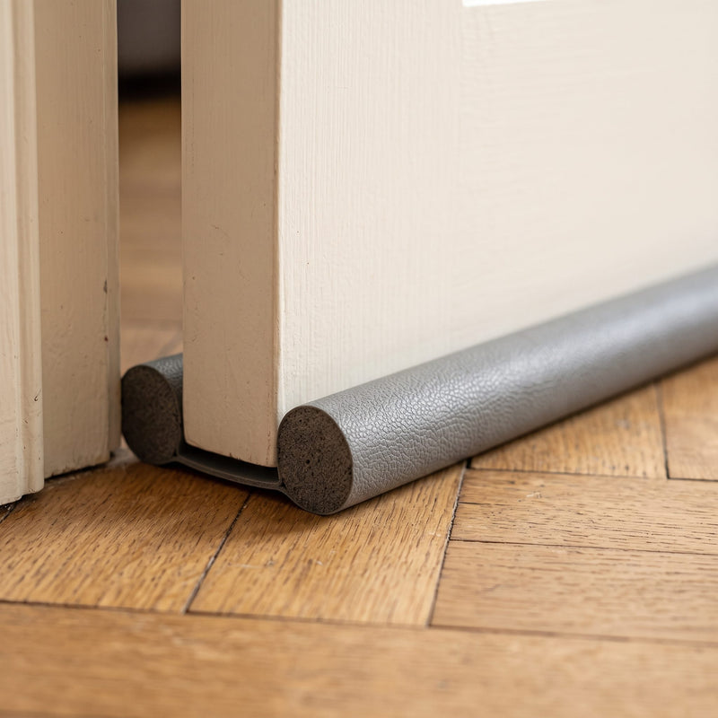 Boudin de porte double glissé sous une porte
